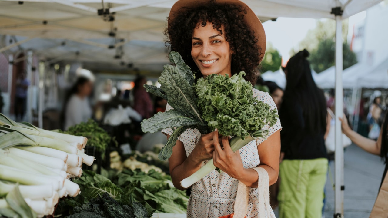 Woman holding kale.